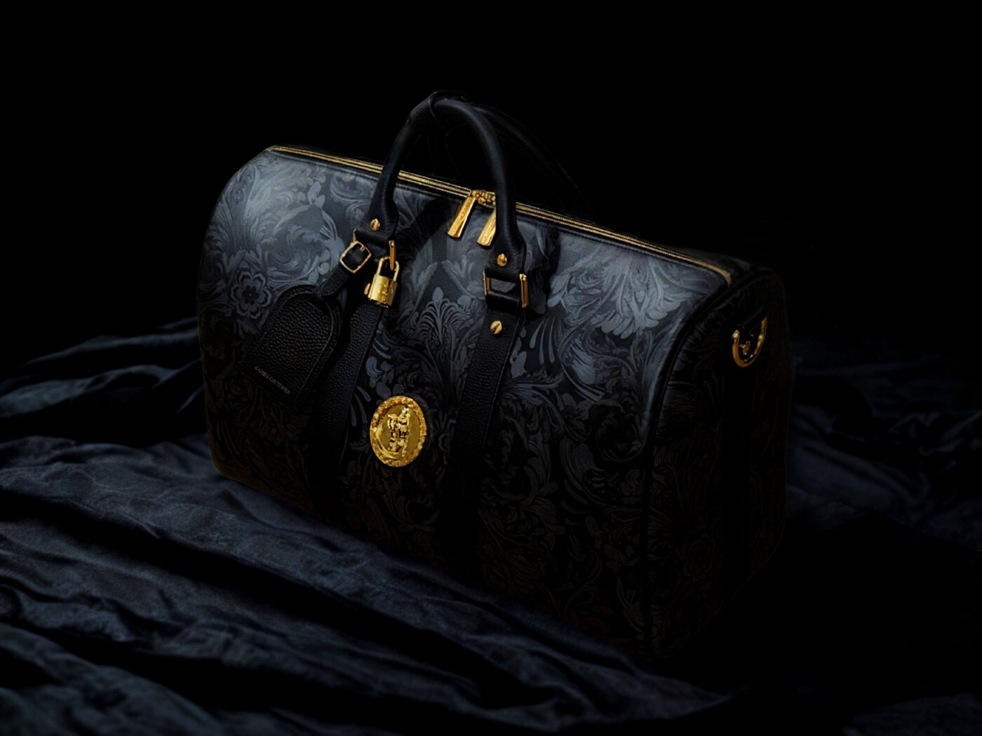 Regalia Voyage Bag in signature black patterned leather with gold hardware